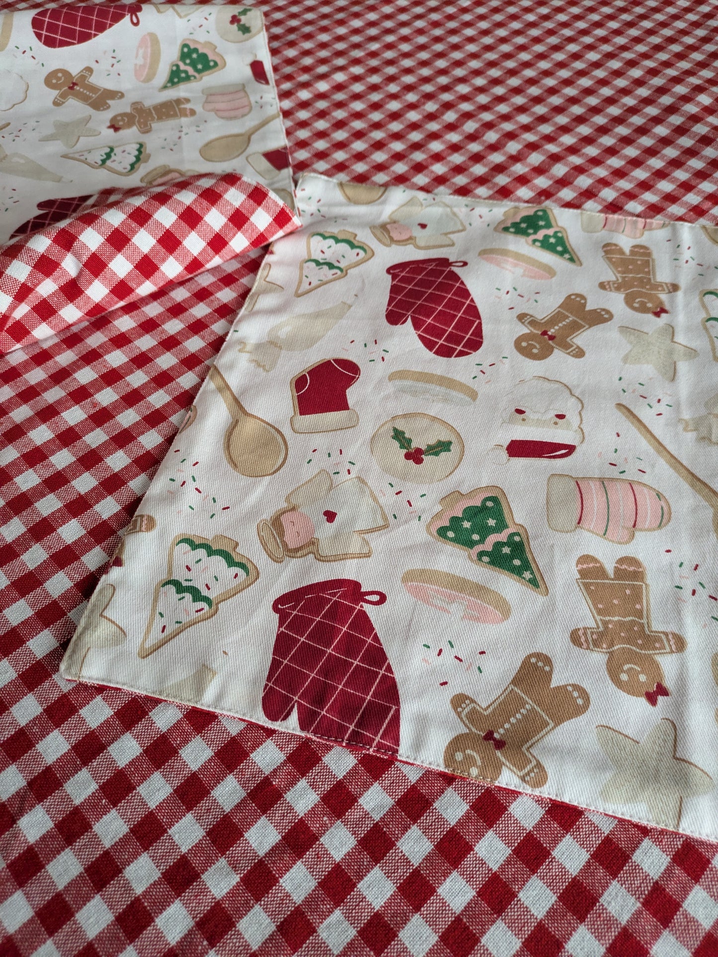Fabric with Christmas-themed designs on a red and white checkered background