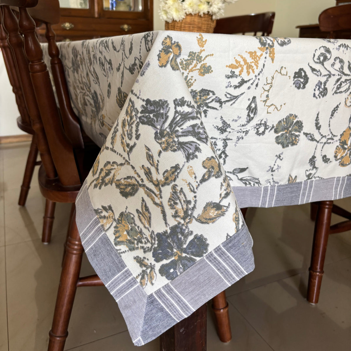 Floral-patterned tablecloth draped over a wooden table