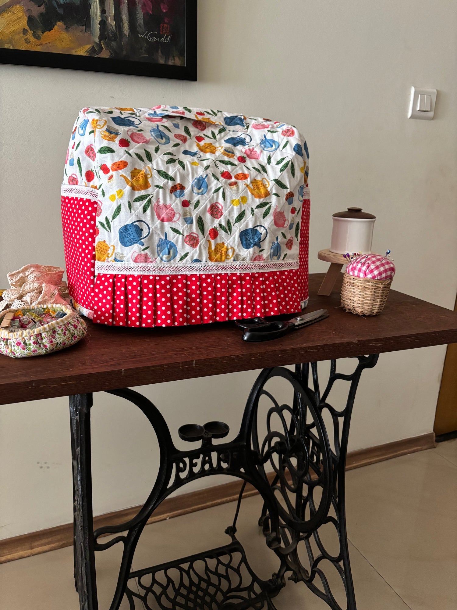 swingmachine table witha fabric sewing machine cover and other sewing notions placed on the table