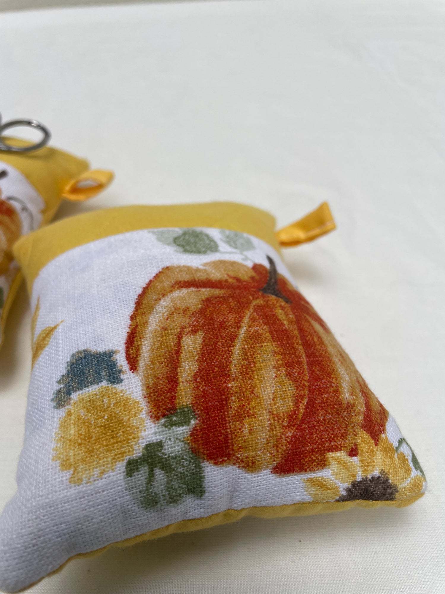 Pincushion with pumpkin design on a white background