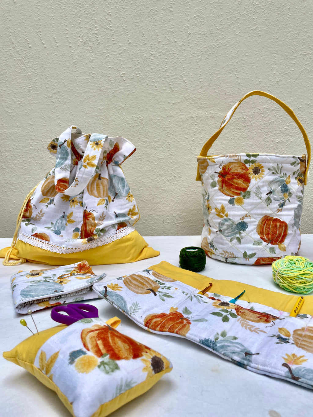 Fabric crafters caddies with pumpkin pattern on a table against a beige wall