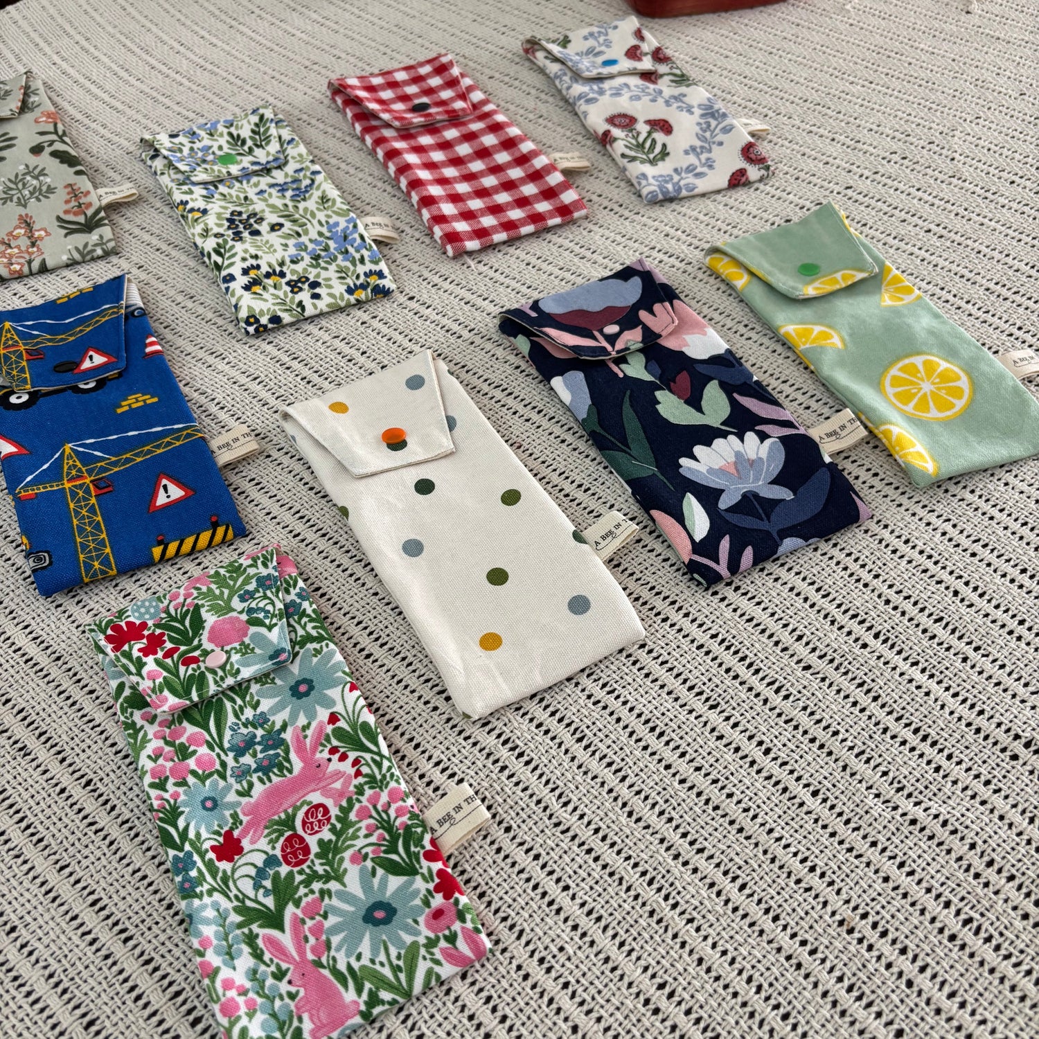 Various colorful fabric pouches on a textured surface