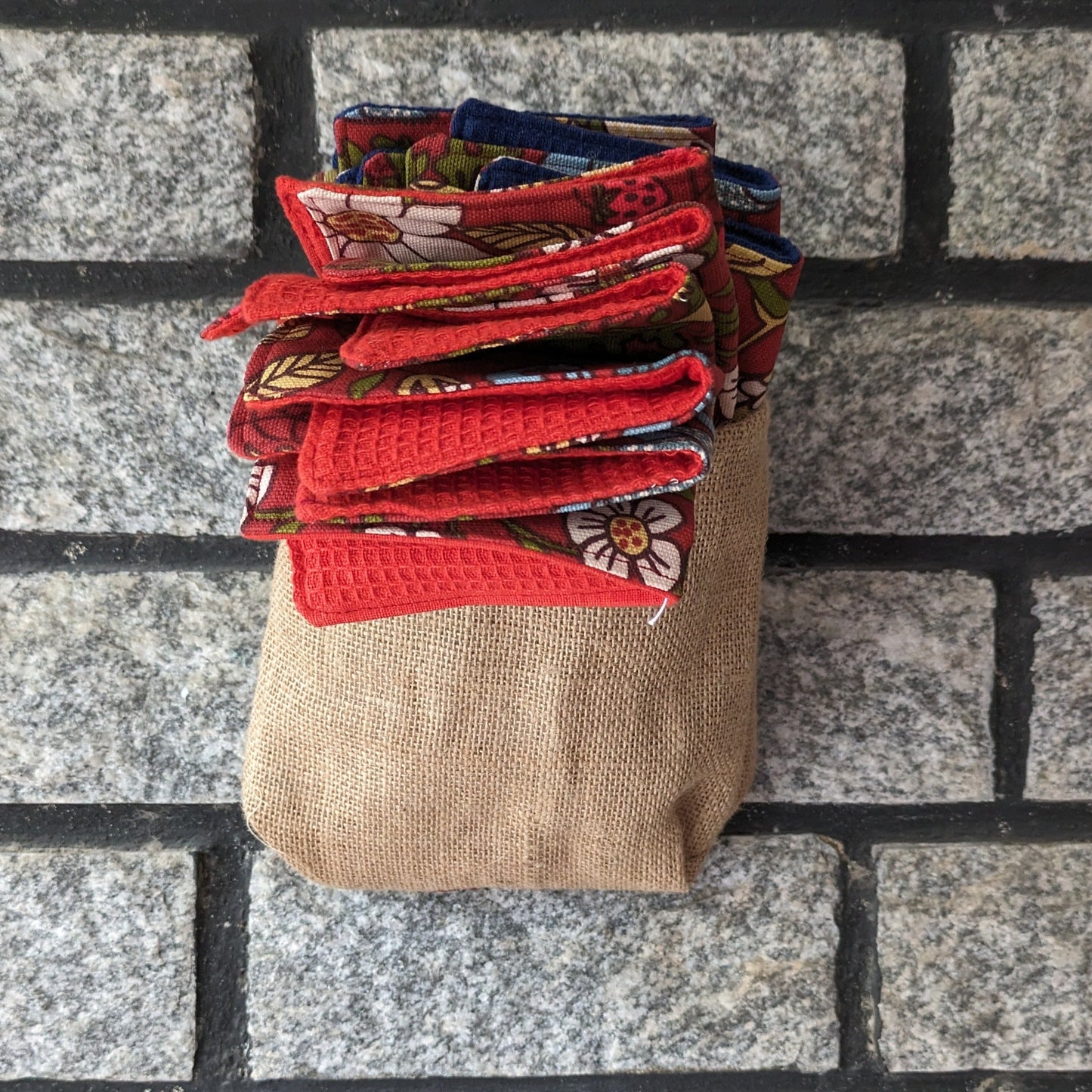 A set of unpaper towels hanging on an Indian Kitchen wall, made in pure cotton and easy to wipe clean. The texture of waffle cotton helps in scrubbing off tough stains