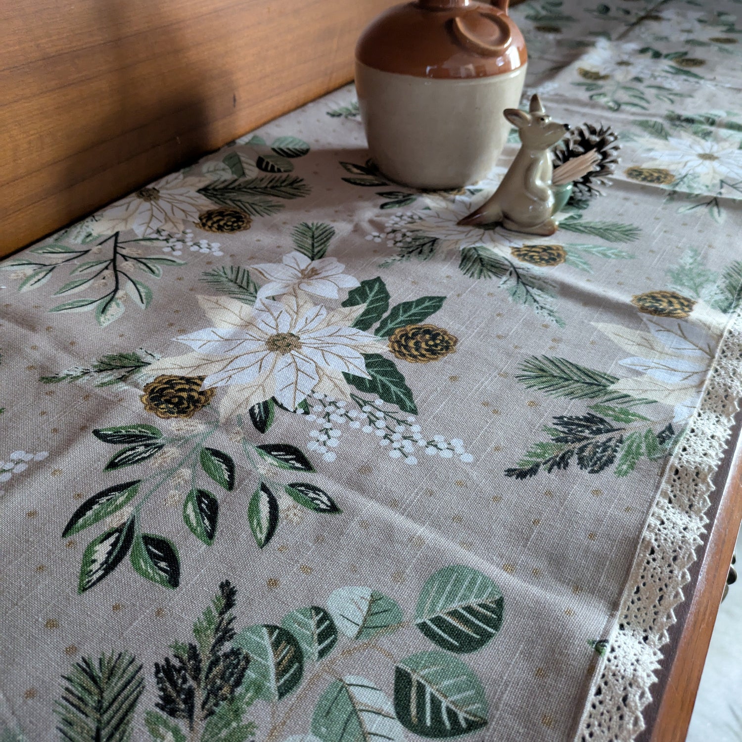 Tablecloth with floral and leaf pattern on a wooden table