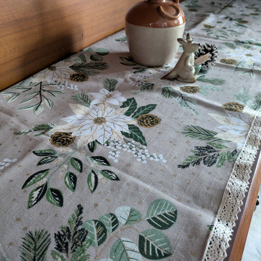 Tablecloth with floral and leaf pattern on a wooden table