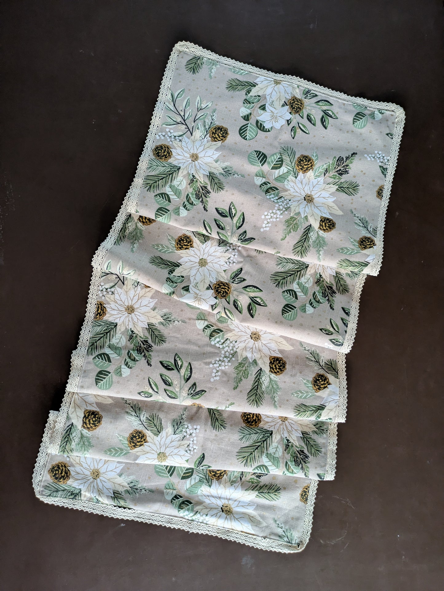 Set of embroidered placemats with floral patterns on a dark surface