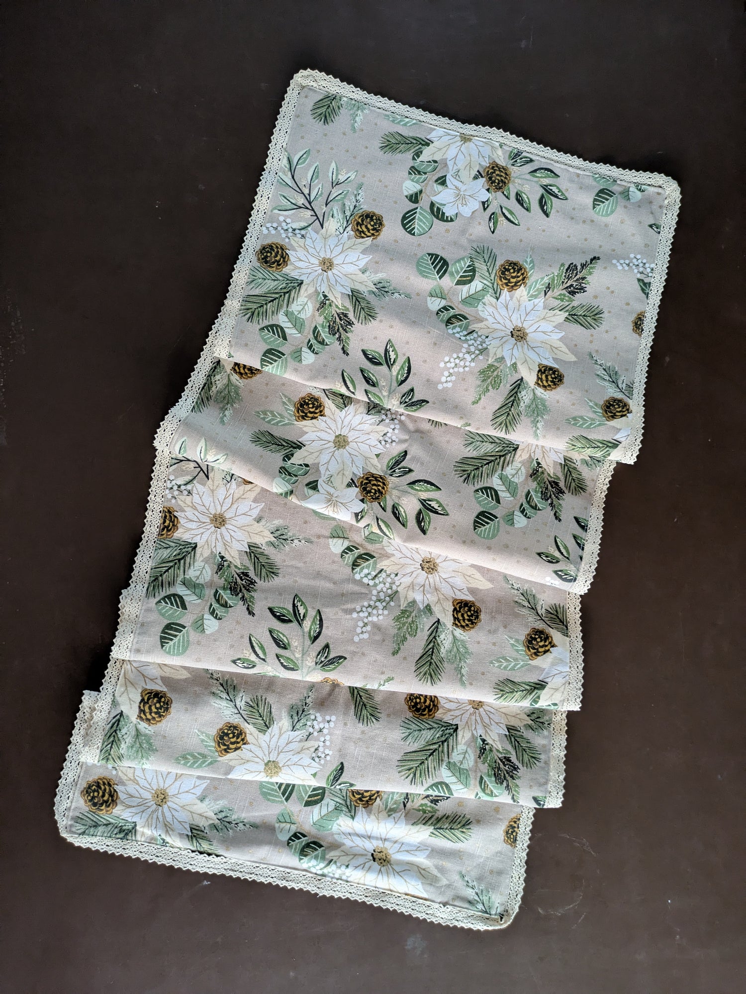 Set of embroidered placemats with floral patterns on a dark surface