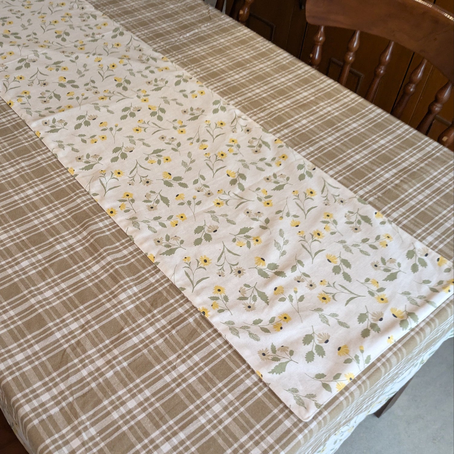Dining table with a checkered and floral patterned tablecloth