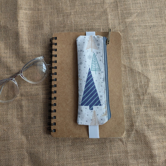 Notebook with a geometric design on a textured surface, it haas an attachable pen sleeve made in fabric