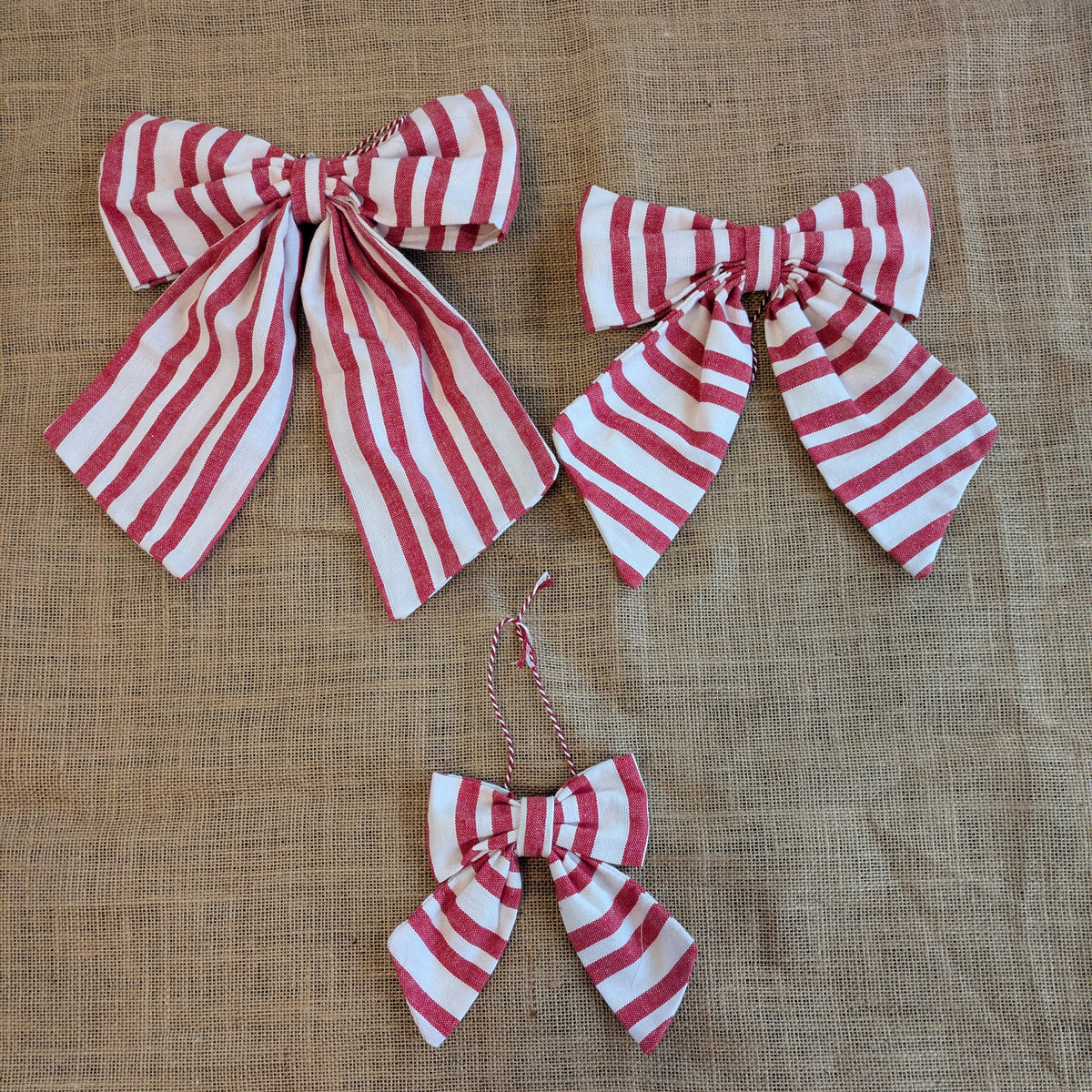 Red and white striped bows on a textured brown background
