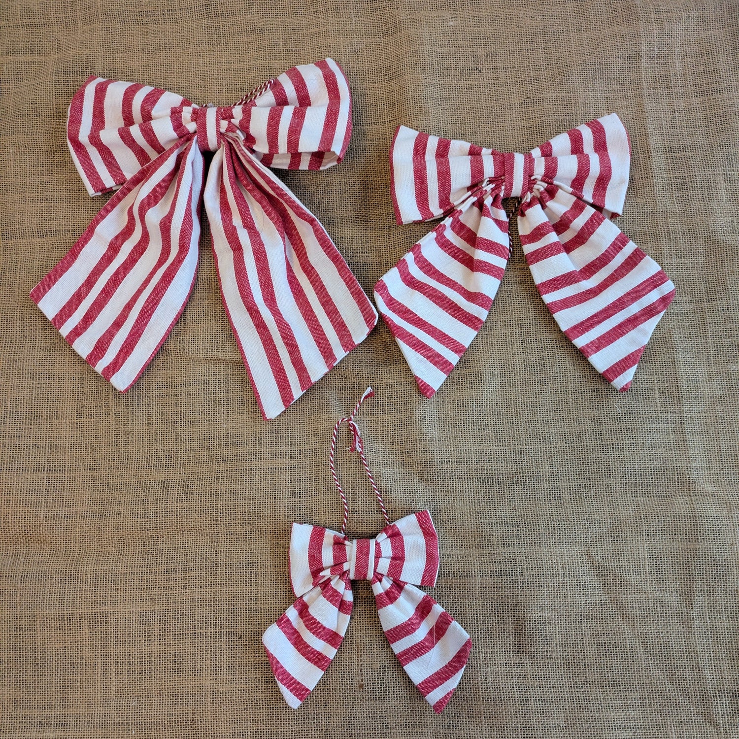 Red and white striped bows on a textured brown background