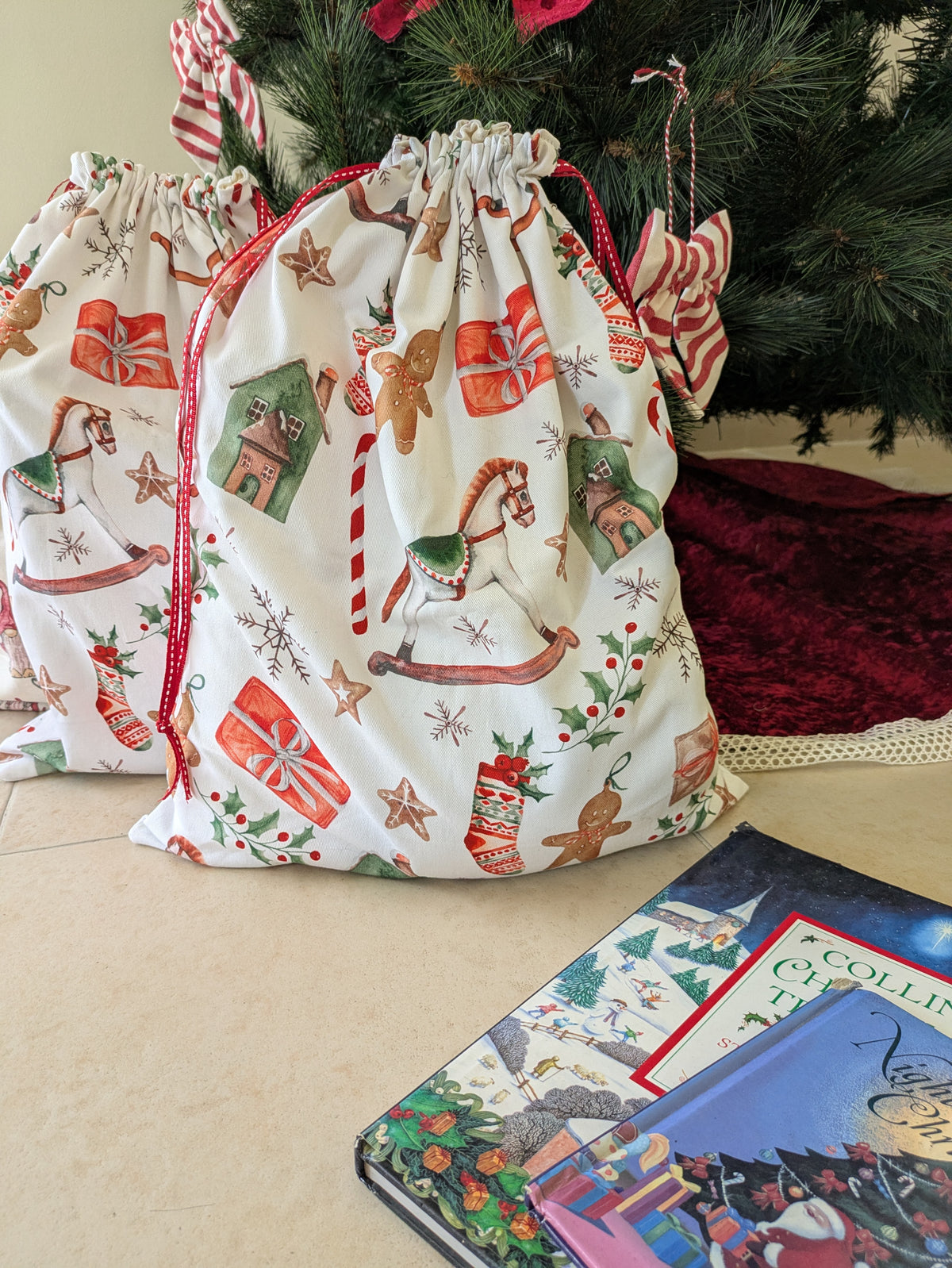 Cotton gift bag with "All Things Merry" print, standing upright with drawstring closure visible