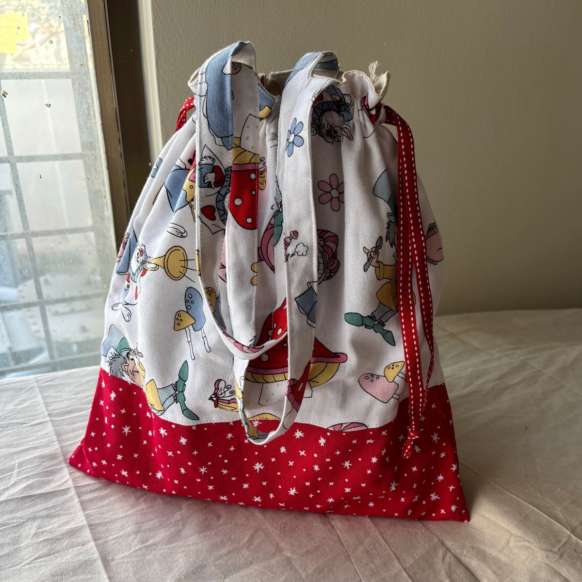 Two fabric bags with different patterns on a light-colored surface.